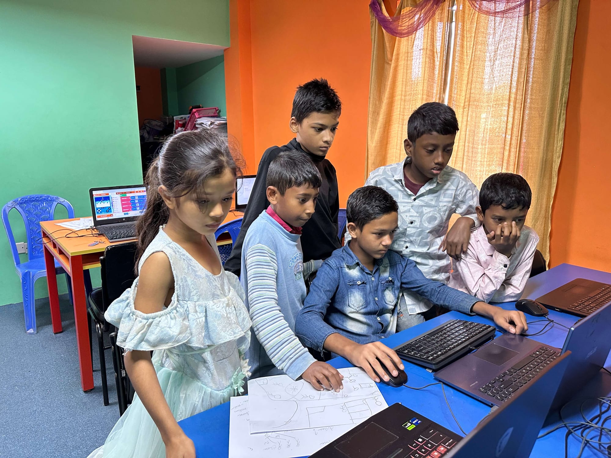 Students working together at laptops in the CAFFE computer room